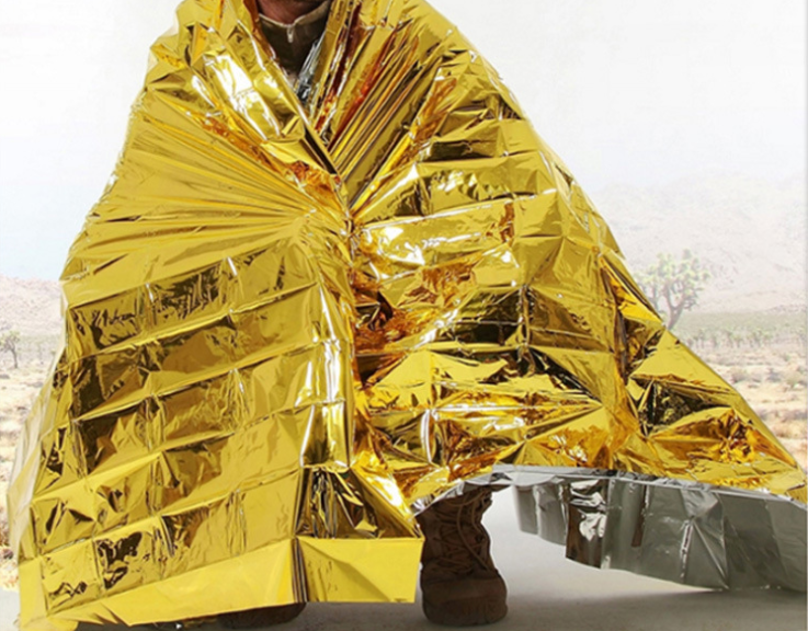 Human Body Hypothermia Lifesaving Emergency Blanket In Outdoor Field